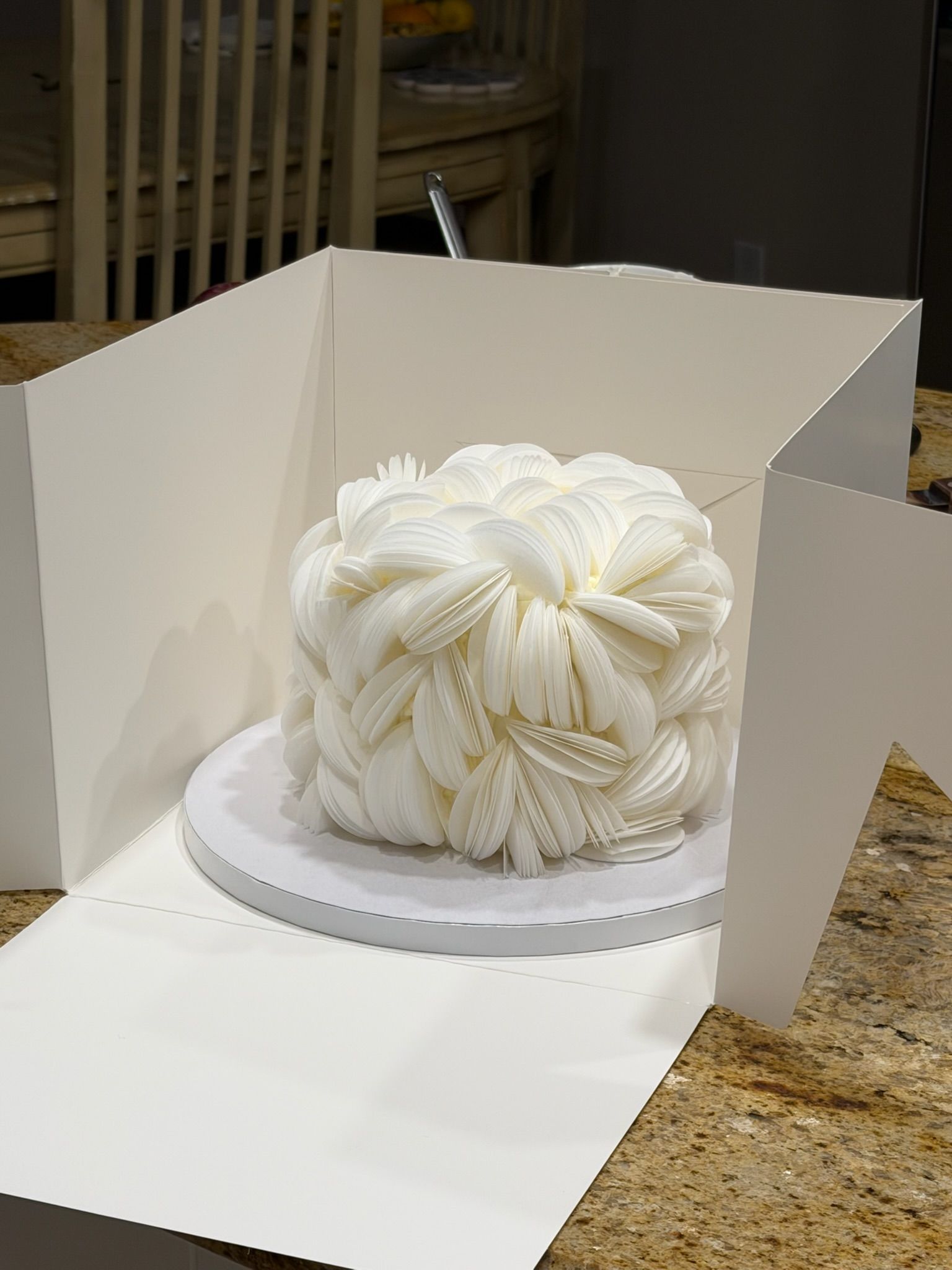 Sculptural cake built entirely from overlapping white buttercream petals