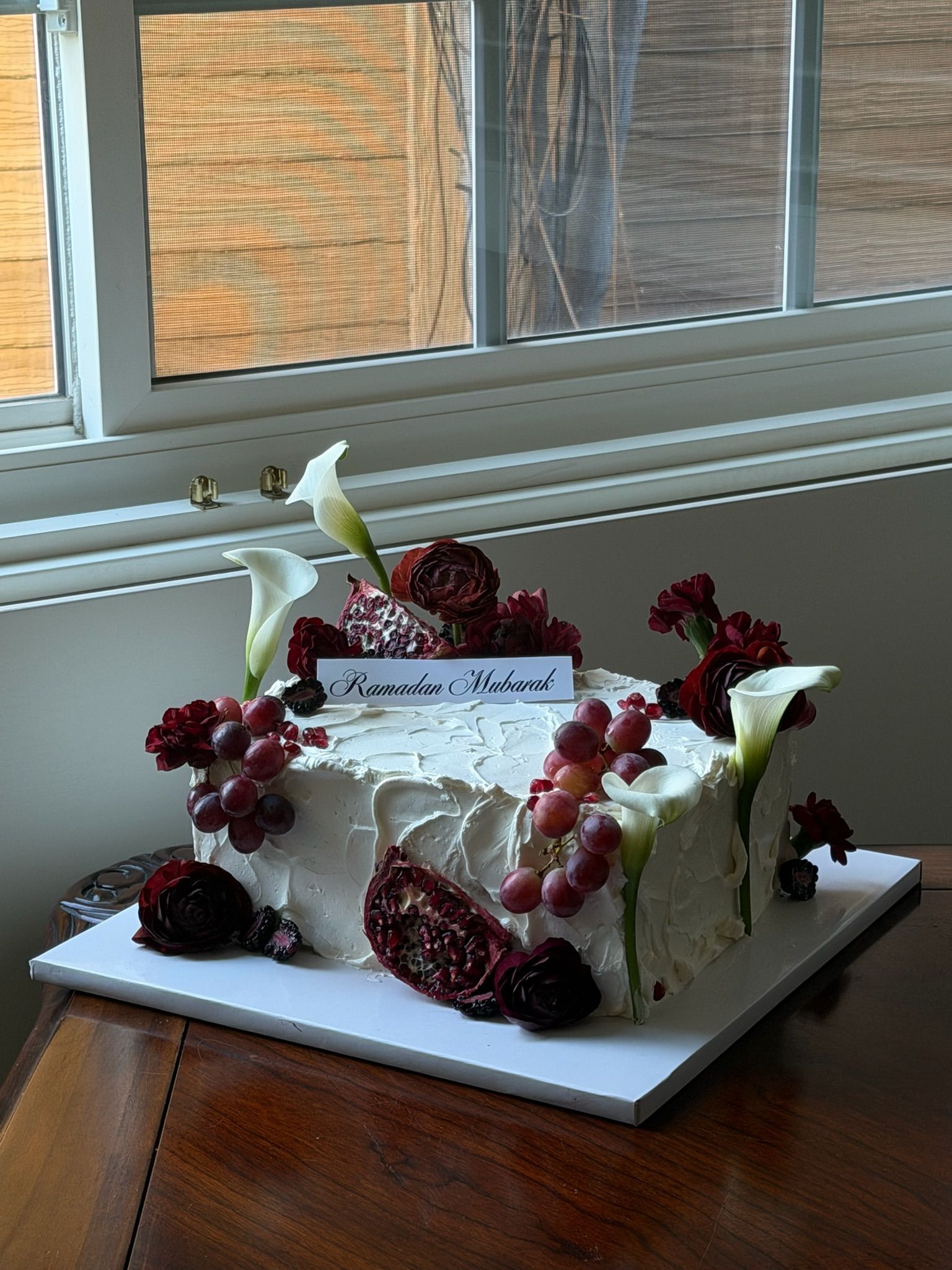 Textured buttercream rectangle cake with pomegranate, red grapes, calla lilies and a Ramadan Mubarak plaque